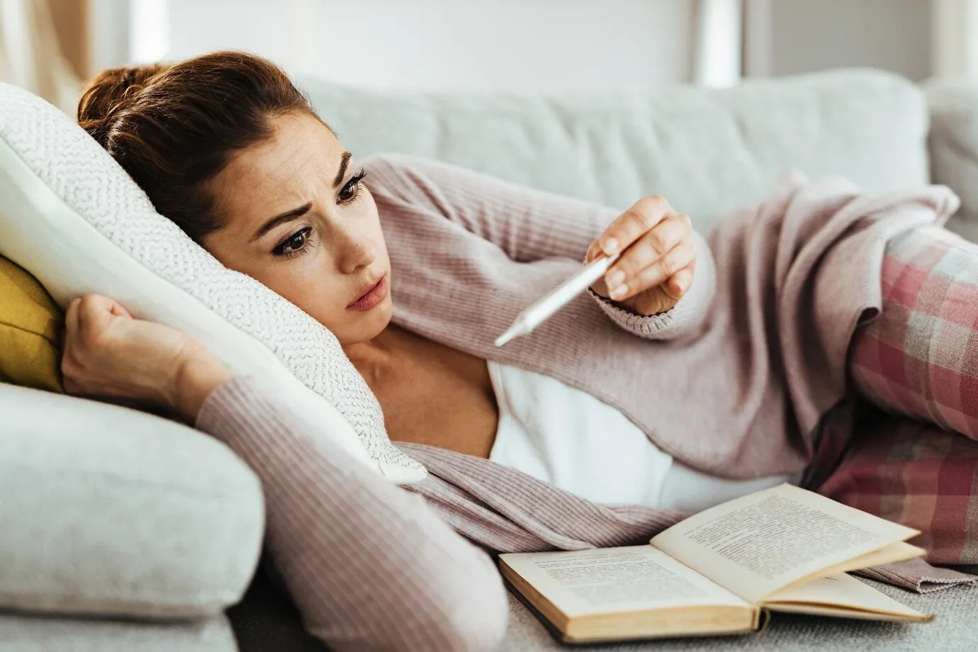 young-woman-using-thermometer-feeling-worried-while-measuring-her-body-temperature-home_637285-4838.jpg